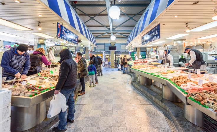 Stall holders preparing and serving food to customers